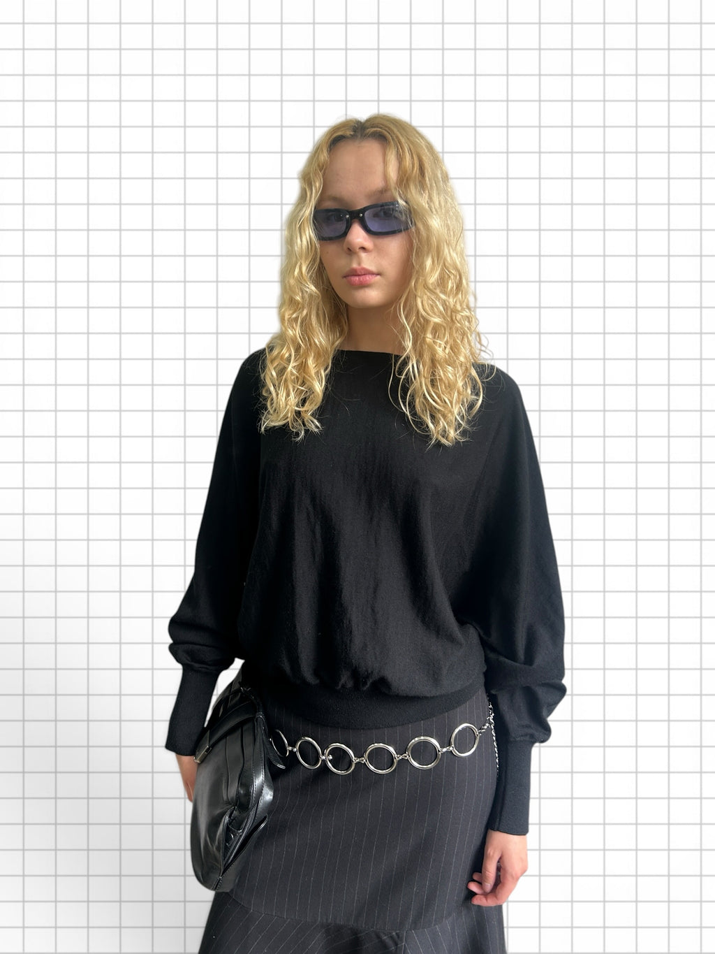 Wieder Wieder black long-sleeve knit sweater with dropped shoulders and ribbed cuffs worn by a blonde model