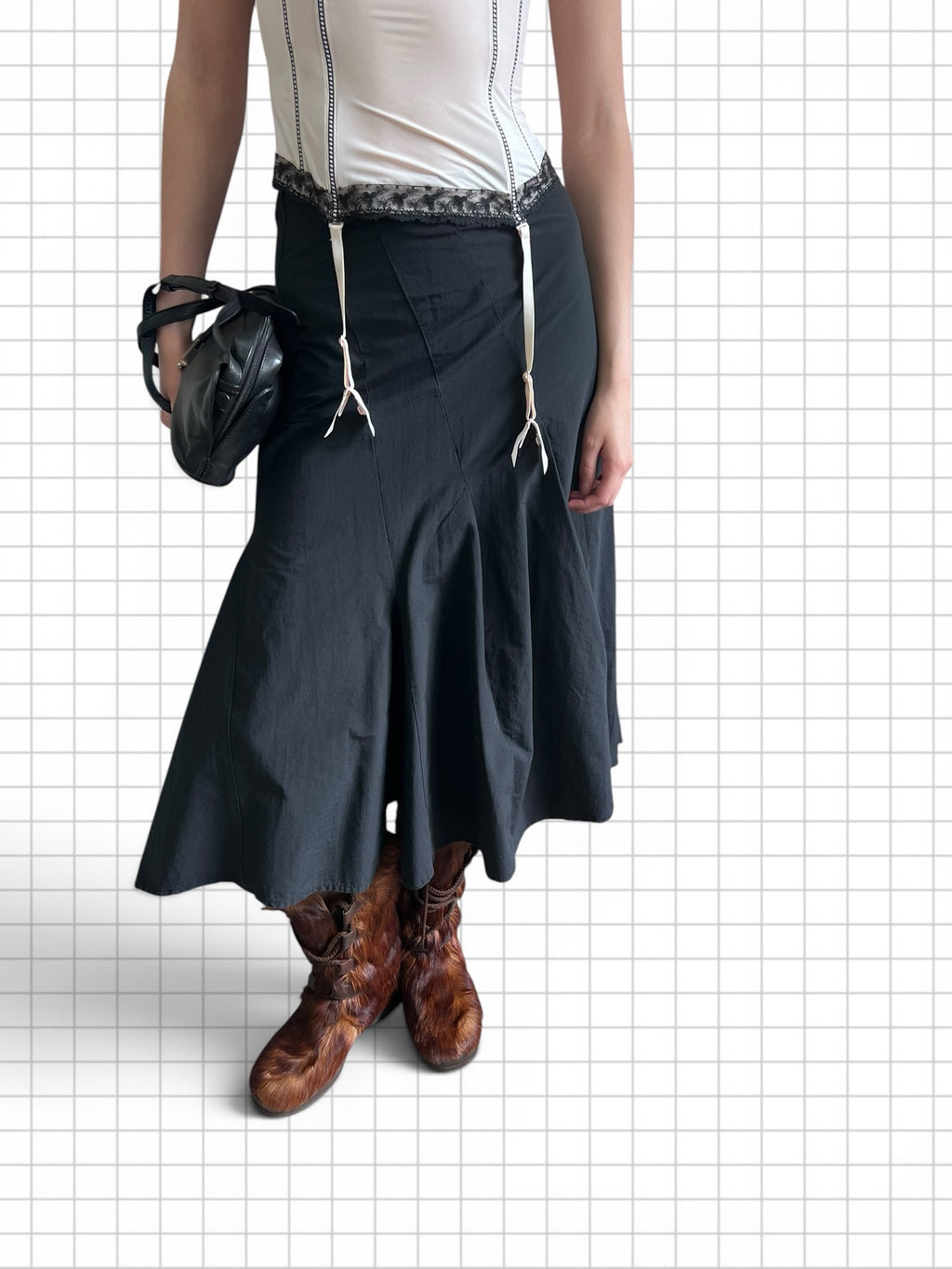 Wieder Wieder black midi skirt with white suspender straps, A-line silhouette, paired with a corset top and boots.