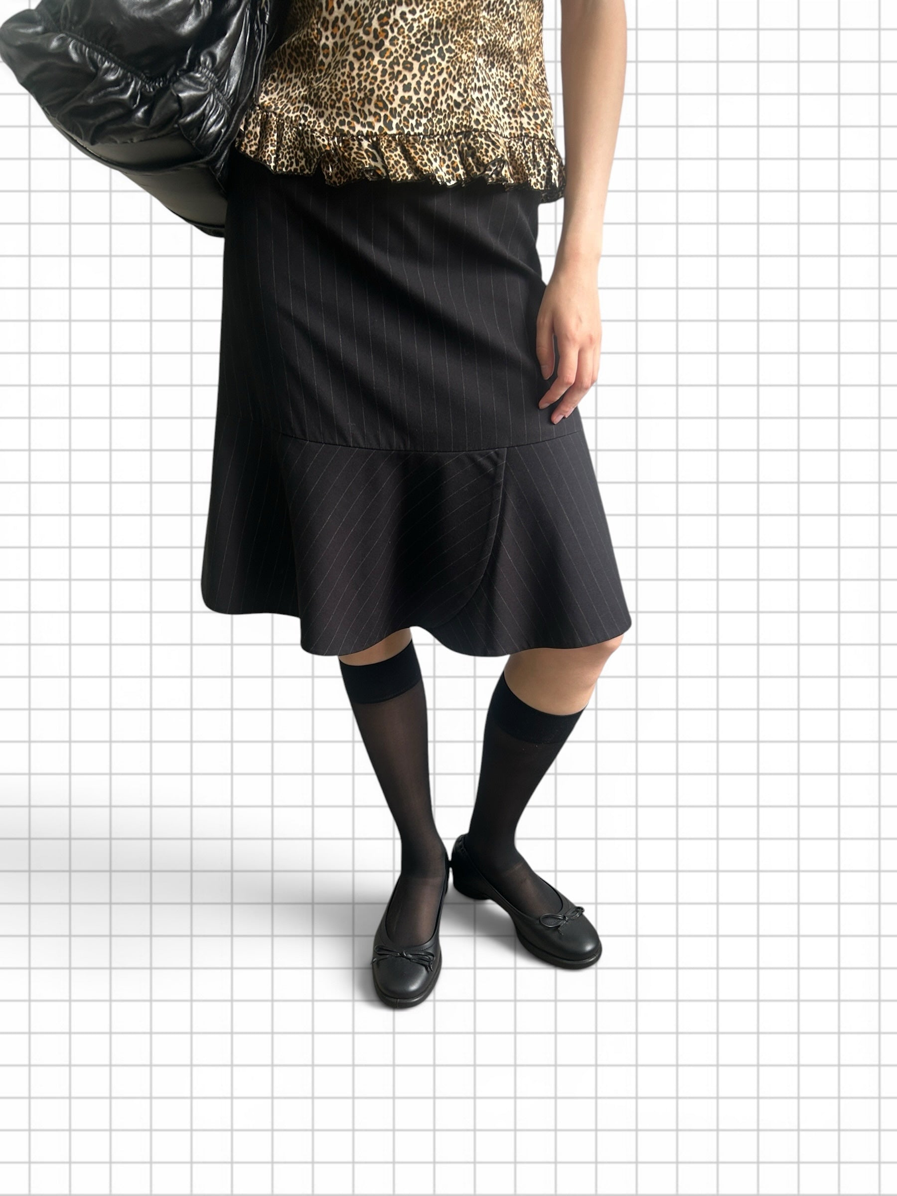 Wieder Wieder black pinstriped midi skirt with a flared hem, styled with black knee-high socks and ballet flats.