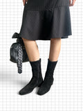 Wieder Wieder black faux suede mid-calf boots with block heel and side zipper worn with a pinstripe skirt