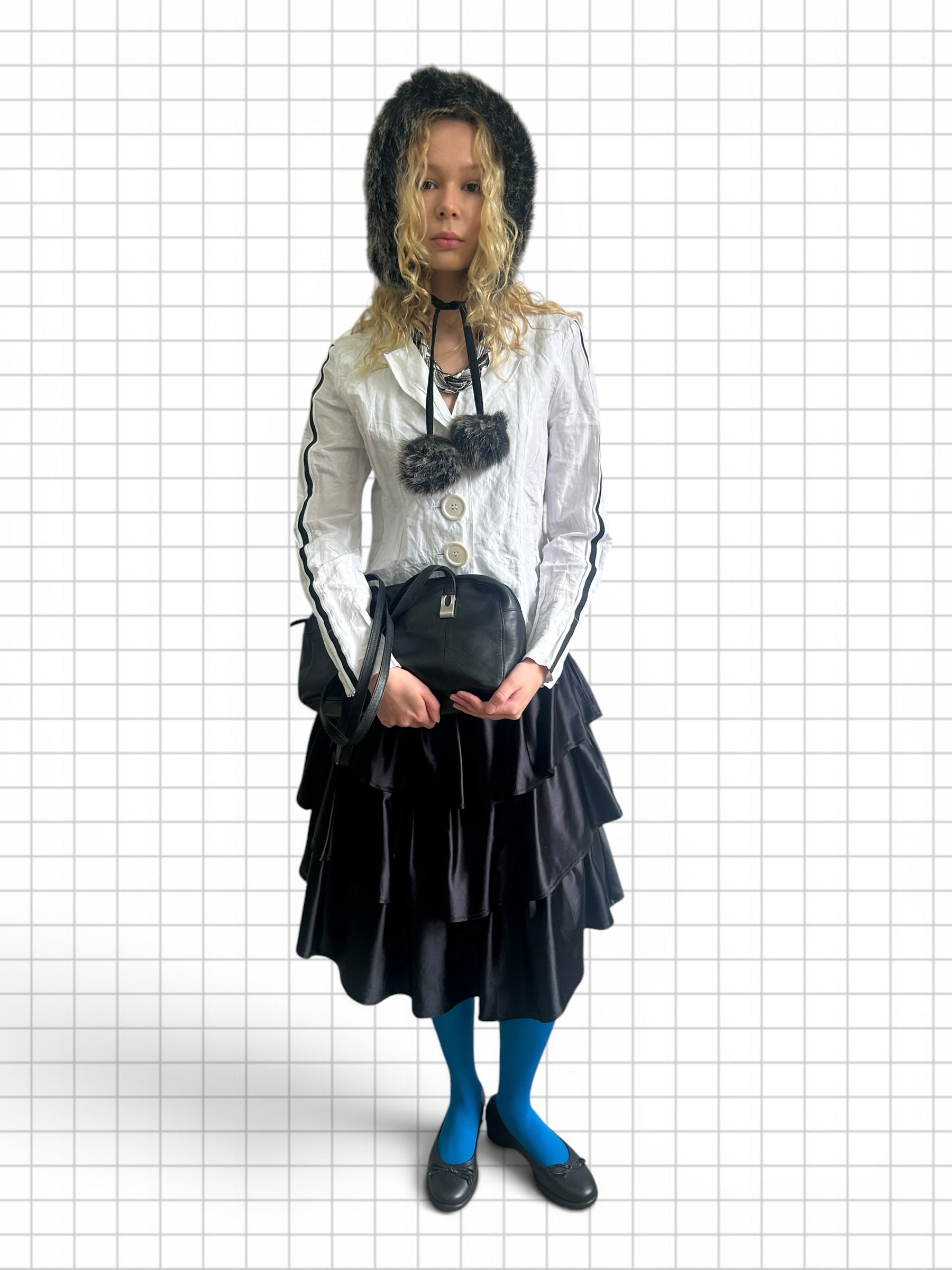 Wieder Wieder black tiered midi skirt with cascading ruffles worn by a model with a faux fur hat and blue tights.