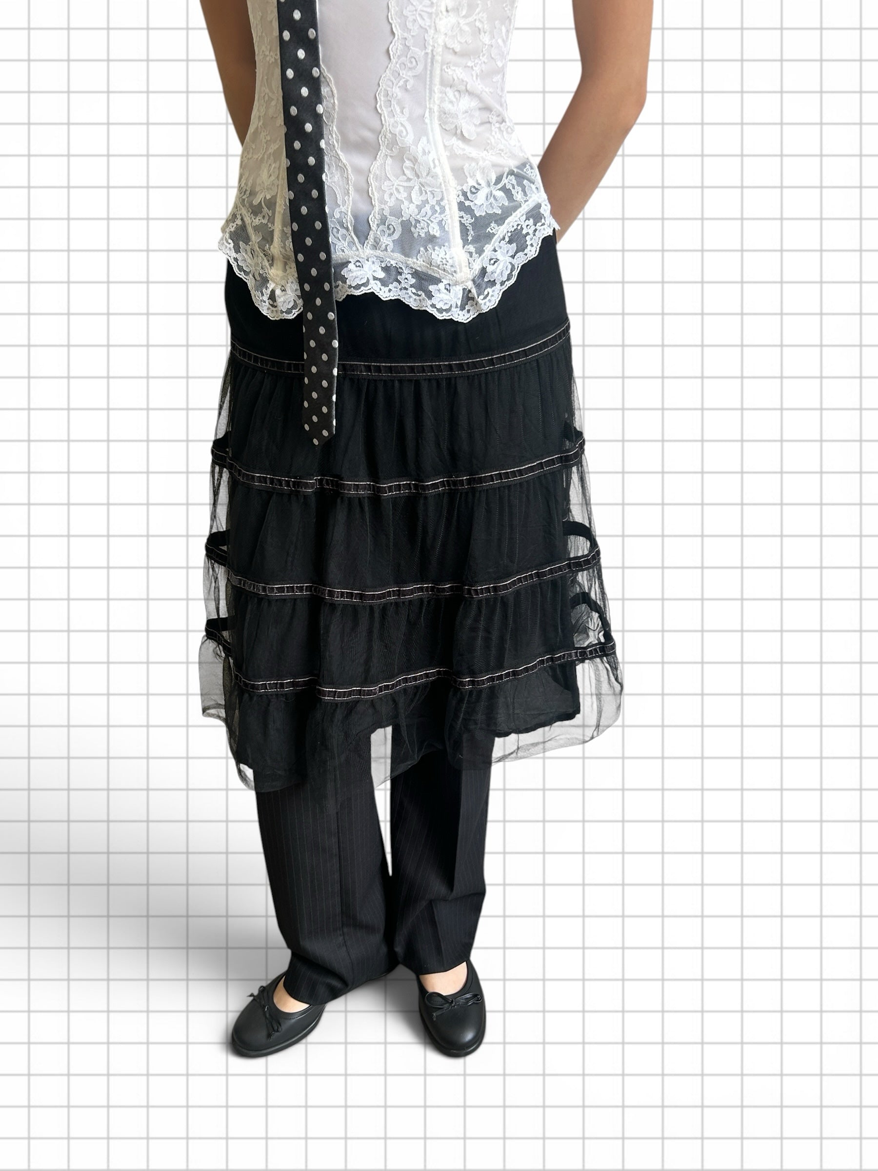 Wieder Wieder black tiered tulle midi skirt layered over pinstriped trousers with a white lace corset top.