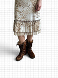 Wieder Wieder brown textured calf hair lace-up winter boots worn with a patterned midi skirt on a grid background
