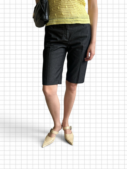 Wieder Wieder charcoal grey pinstripe Bermuda shorts with a tailored knee-length fit worn with a yellow crochet top.
