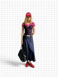 Wieder Wieder dark blue satin midi skirt with suspender straps worn by a model with a pink top and red accessories.