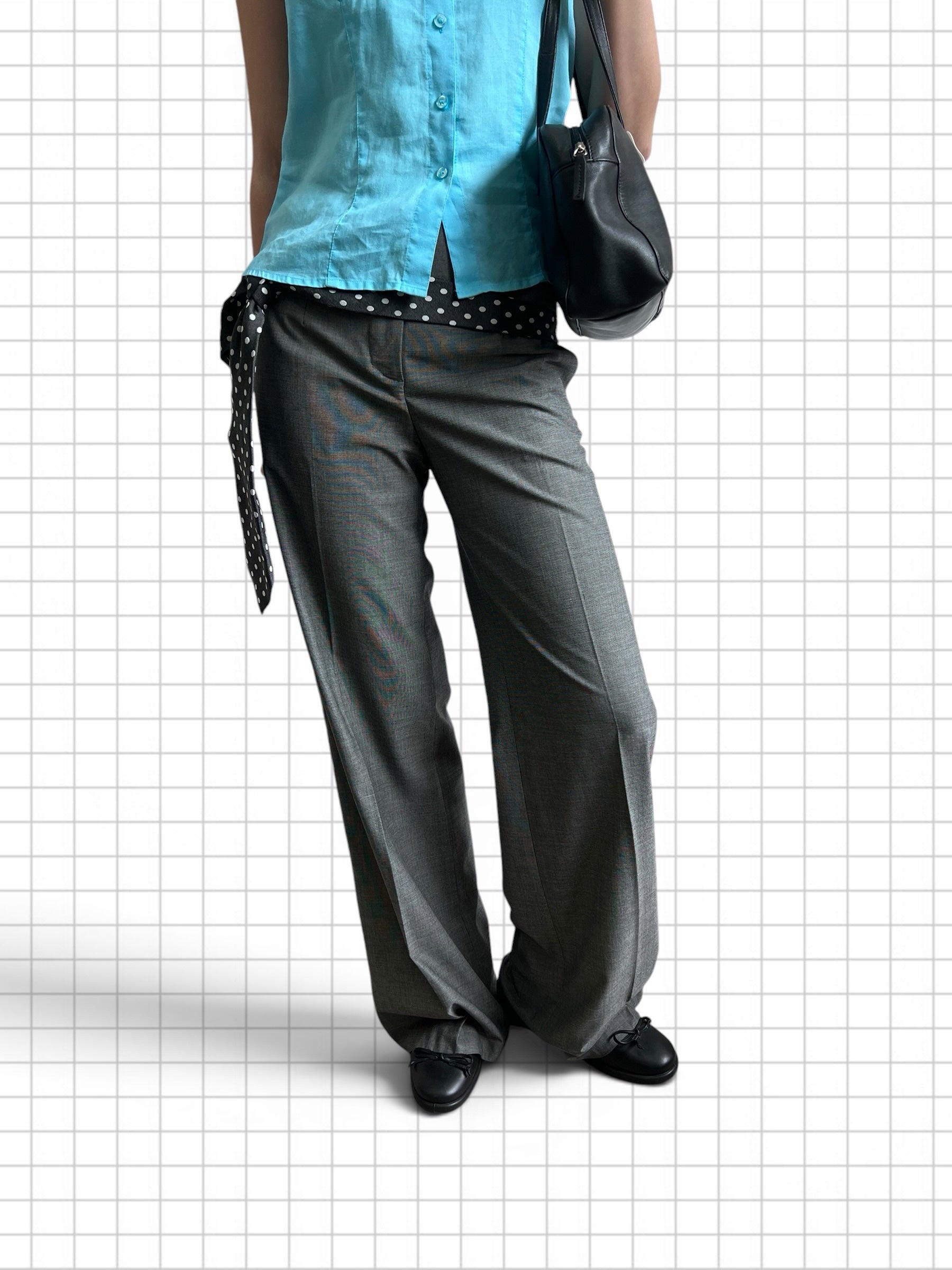Wieder Wieder grey high-waisted wide-leg tailored trousers with a pressed crease, worn with a blue shirt and black bag.