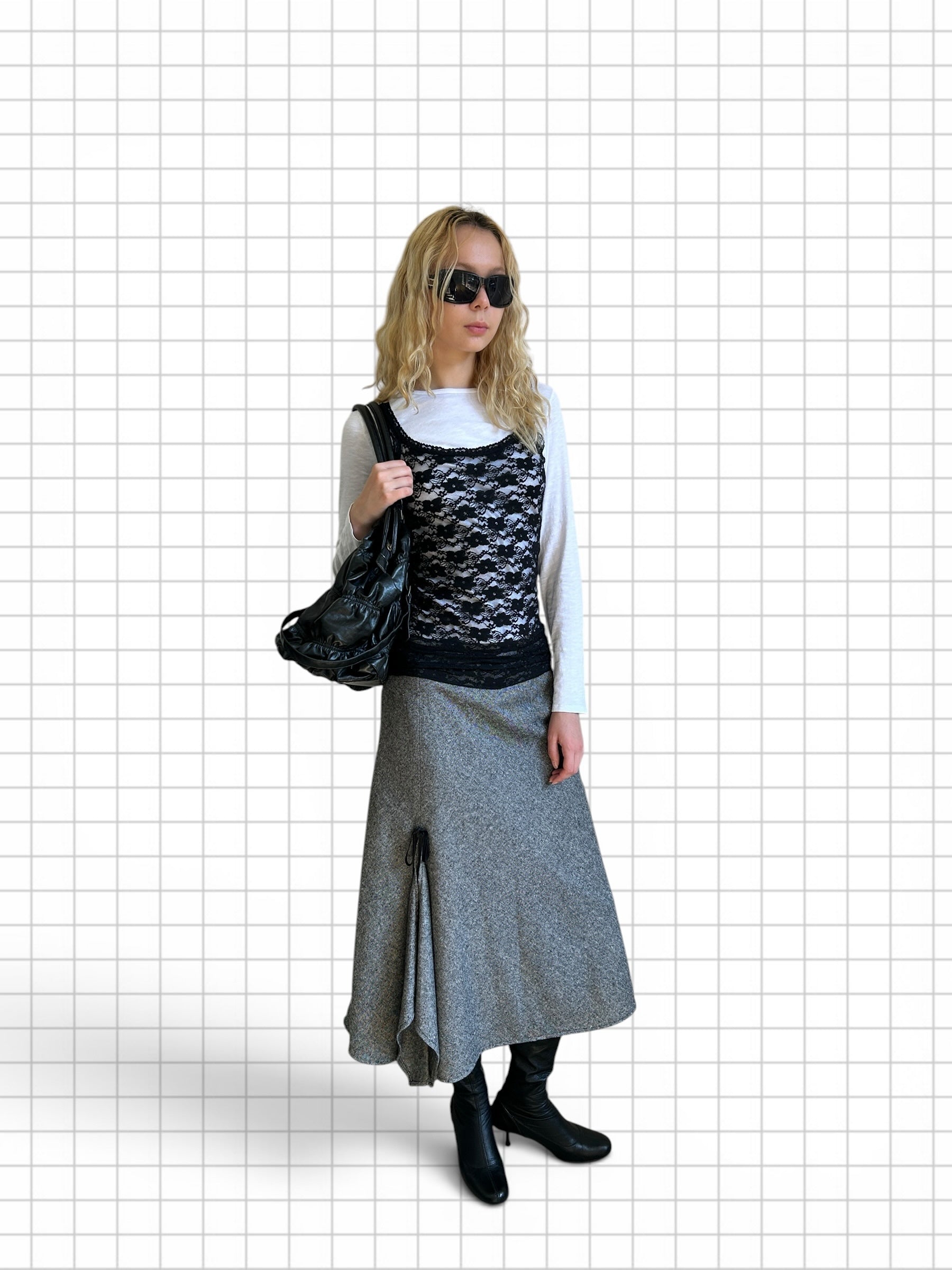 Wieder Wieder grey wool-blend midi skirt with asymmetrical hem and ribbon detail worn by a model with black boots.