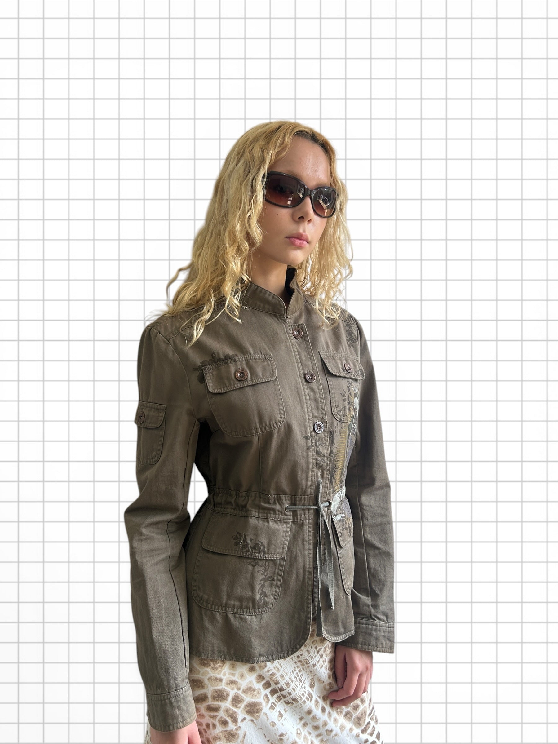 Wieder Wieder olive utility jacket with mandarin collar, button front, and intricate chest embroidery on a model.
