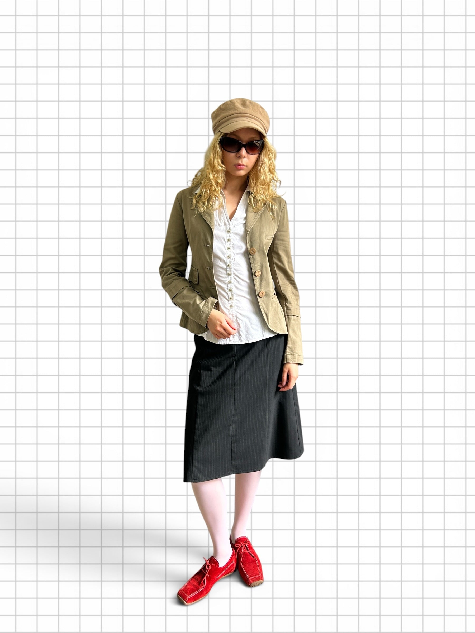 Wieder Wieder tailored olive blazer jacket worn by a model with a white shirt, black skirt, and red shoes.