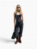 Wieder Wieder pinstriped trousers with elasticated cuffs, styled with a black top, scarf, and boots on a model.