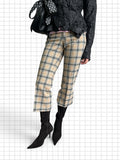 Wieder Wieder plaid cropped trousers in beige with black and red check pattern, styled with black boots.