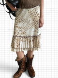 Wieder Wieder midi skirt in neutral snakeskin print with a ruffled hem and contrast trim, styled with fur boots.